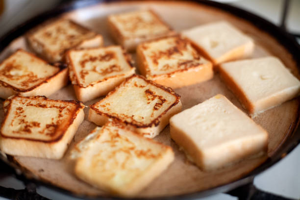 istock Yummy square-shaped  croutons fried in a pan. 1302847947