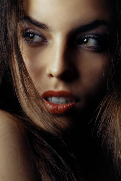 istock Beautiful woman with red lips looking sideways 1302850107