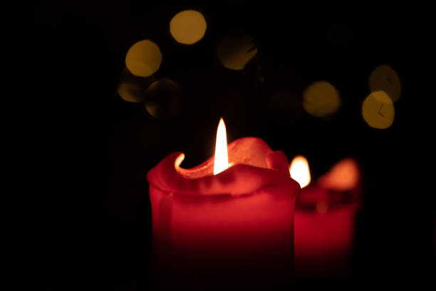 istock Red round candle burning with bokeh lights background 1302850136