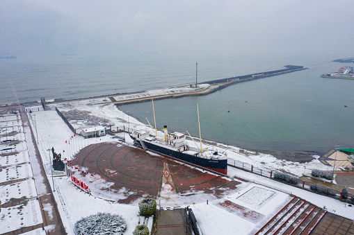 Canik, Samsun / Turkey - 16 February 2021: Monument of the first step of the national liberation struggle in Bandirma Ferry and National Struggle Park Open Air Museum in a snowy day. Aerial view.