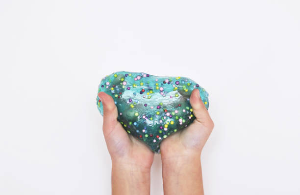 istock Child hands with slime on white background. 1302852745