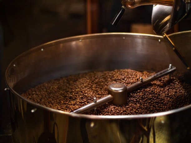 istock Coffee Roaster With Roasted Coffee Beans Close-up 1302854124