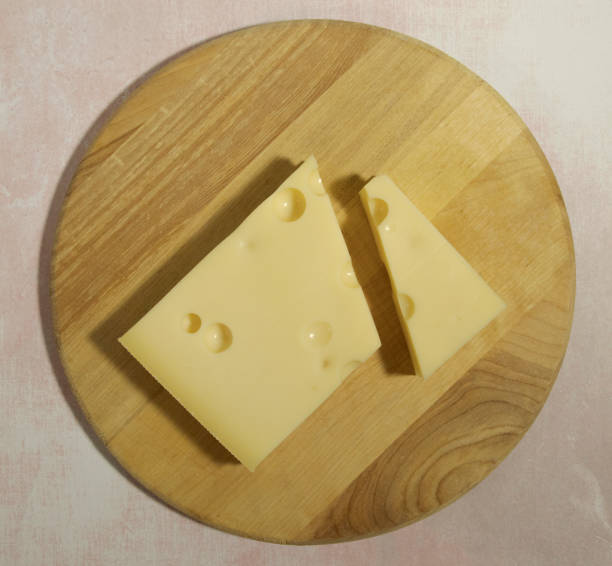 istock Emmental cheese close up on a cutting round board 04 1302855841