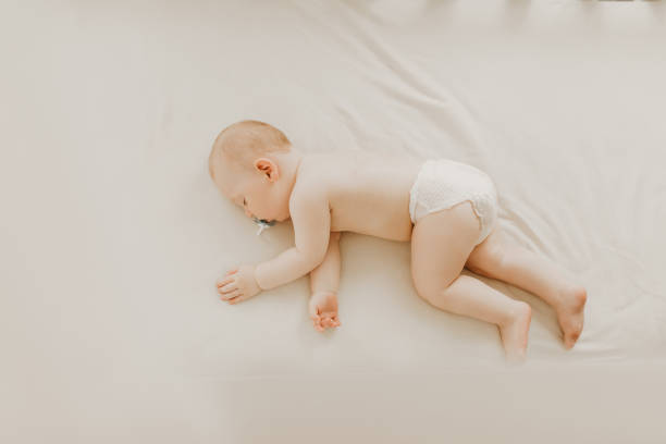 istock Sleeping little baby in a diaper sleeps in a crib 1302856586