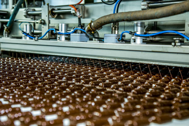 istock Sweets factory. Sweets production process. Conveyor belt with sweets on it. 1302856696