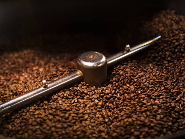 istock Coffee Roaster With Roasted Coffee Beans Close-up 1302857008