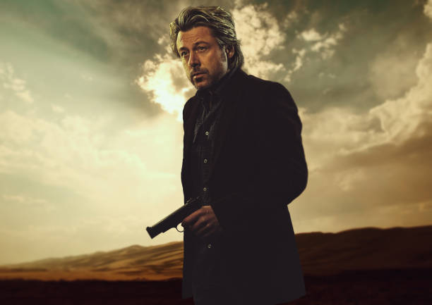 Cropped Hands Of Man Holding Gun