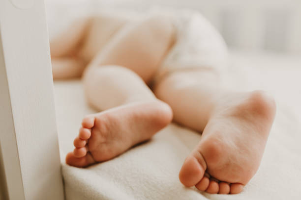 istock Sleeping little baby in a diaper on the bed 1302857541