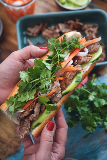 istock Preparing Vietnamese Banh Mi Sandwich 1302863512