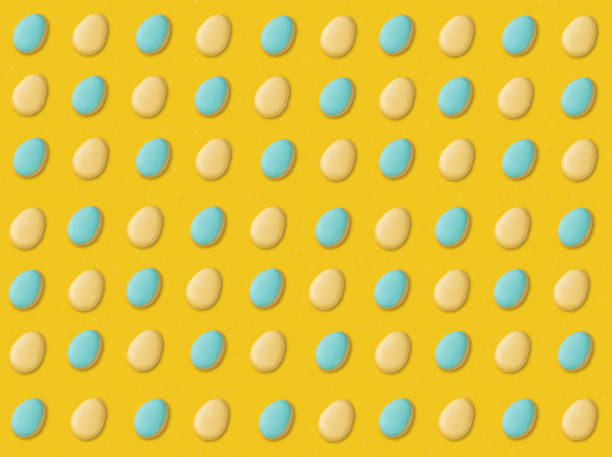 istock Blue and yellow easter egg cookies over yellow background 1302864550