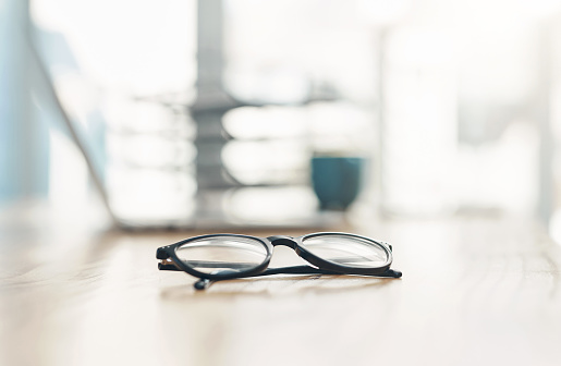 Closeup shot of spectacles on a table in an office