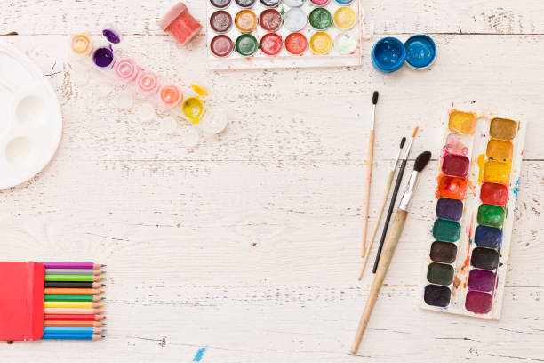 istock Top view on colorful paints and brushes. Creative ideas, creativity and early learning. Education concept. 1302869213