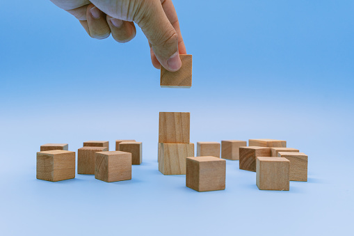 Hand Stacking Wooden Block. Business and Personal Development Concept.