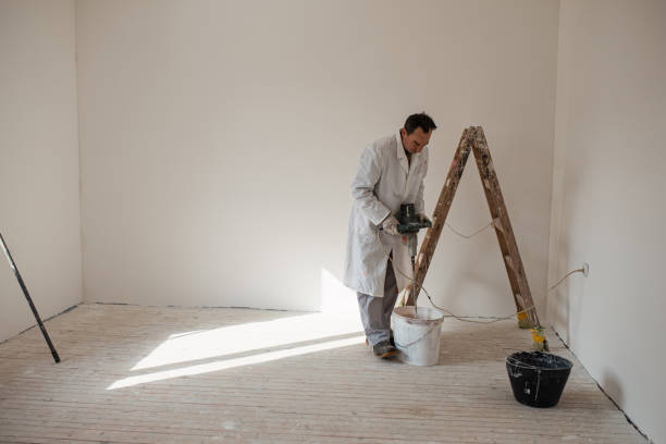 istock Mature man preparing paint and plaster for wall decoration. 1302872304