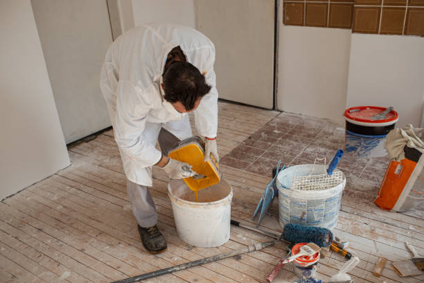 istock Mature man preparing paint and plaster for wall decoration 1302872442