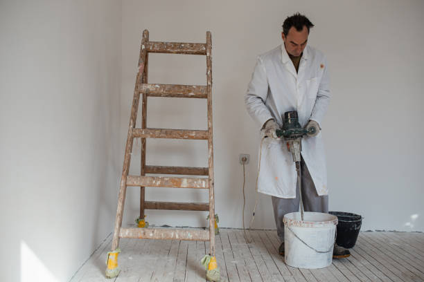 istock Mature man preparing paint and plaster for wall decoration. 1302872659