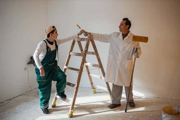 istock Father and son painting walls 1302873326