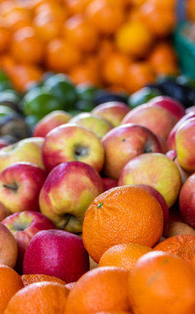 Farmers market, red and yellow apples, oranges, fresh and colorful, on display. stock photo