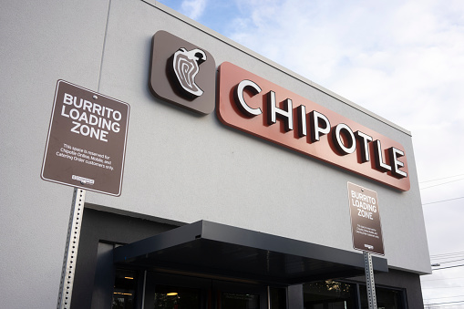 Portland, OR, USA - Dec 14, 2020: The Burrito Loading Zone parking signs are seen at the entrance to a newly-opened Chipotle Mexican Grill restaurant in Portland, Oregon.
