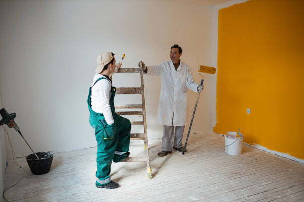 istock Son helping father to paint the walls 1302875746