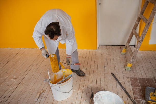 istock Man is taking paint from utensil 1302875843