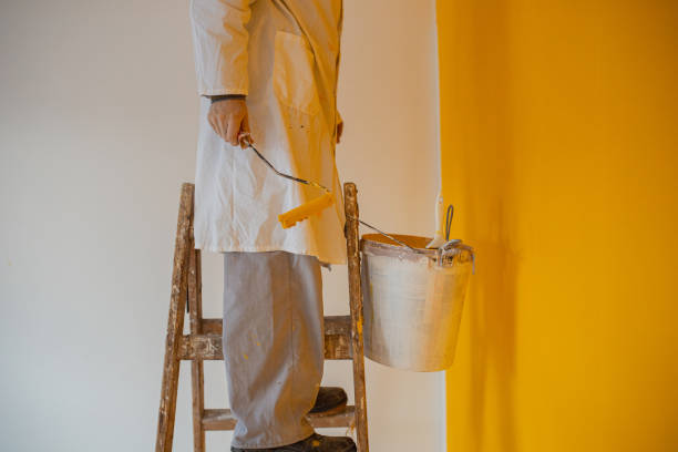 istock Man stands on the ladder 1302875990