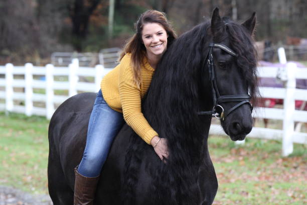 istock Bareback Rider and her Friesan Horse 1302876632