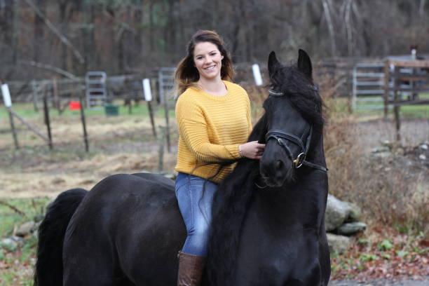 istock Bareback Rider and her Friesan Horse 1302876640