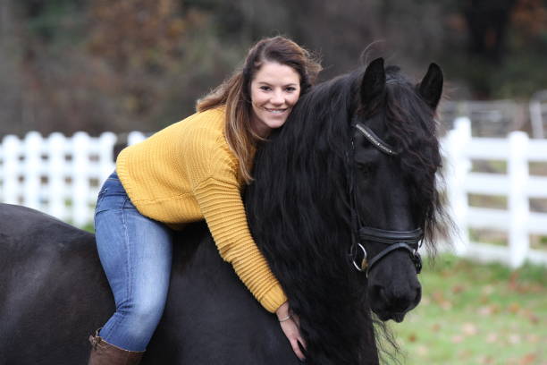 istock Bareback Rider and her Friesan Horse 1302876641