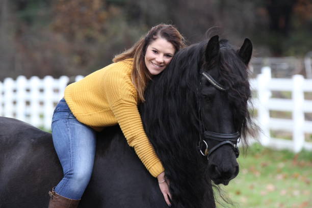 istock Bareback Rider and her Friesan Horse 1302876642