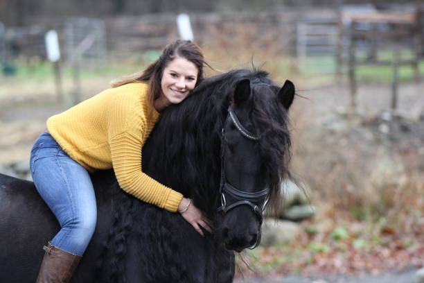 istock Bareback Rider and her Friesan Horse 1302876643