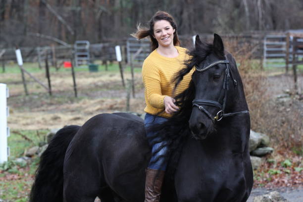 istock Bareback Rider and her Friesan Horse 1302876644