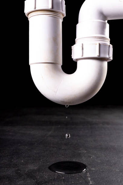 istock Water leaking from the drain pipe. Household drainage failure. Dark background. 1302876674