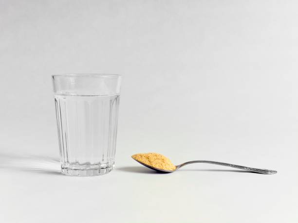 psyllium husk fiber therapy to support regularity. The orange flavored powder made into a drink keeps things flowing. On white with copy space.
