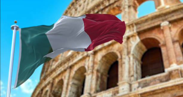 The Italian flag flapping in the wind with the Colosseum blurred in the background The Italian flag flapping in the wind with the Colosseum blurred in the background. Travel and tourism. Tourist attraction in Italy. Ancient Roman Empire and History. Flavian Amphitheater rome italy photos stock pictures, royalty-free photos & images