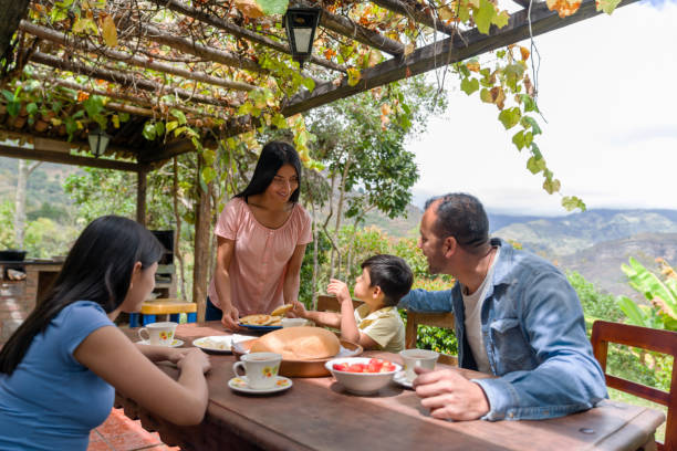 istock Woman serving arepas while having a traditional breakfast with her family 1302887734