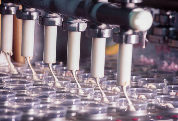 close up machines filling fresh water to glass bottles