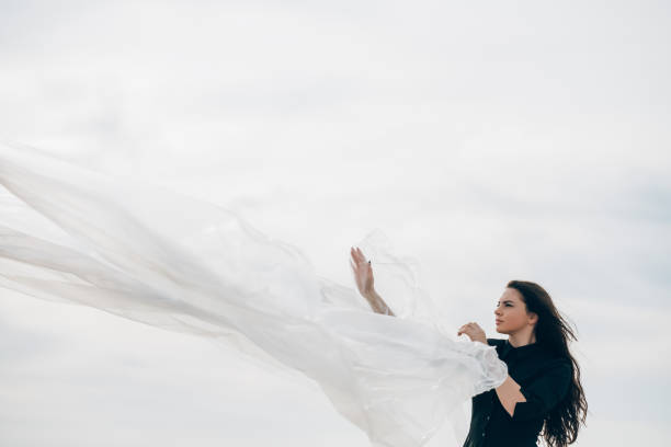 istock woman leadership feminist empowerment wind sky 1302891136