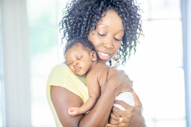 istock A mom carrying her sleeping baby 1302891429