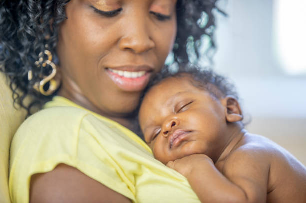 istock Newborn baby sleeping on mother's chest 1302891435