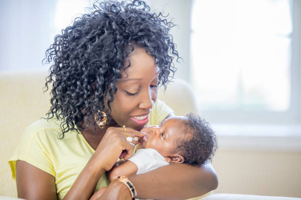 istock Mother cradles her newborn baby 1302891437