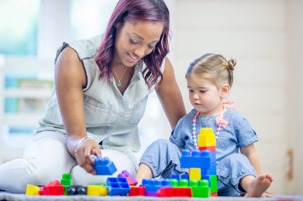 istock Preschool teacher and student 1302891456
