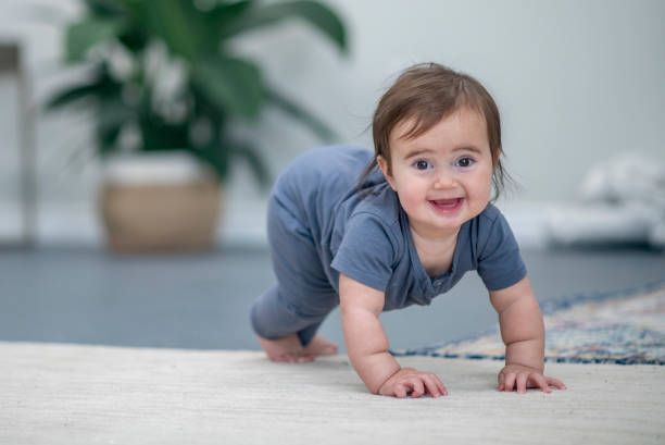 istock Cute baby girl is learning to crawl 1302891495