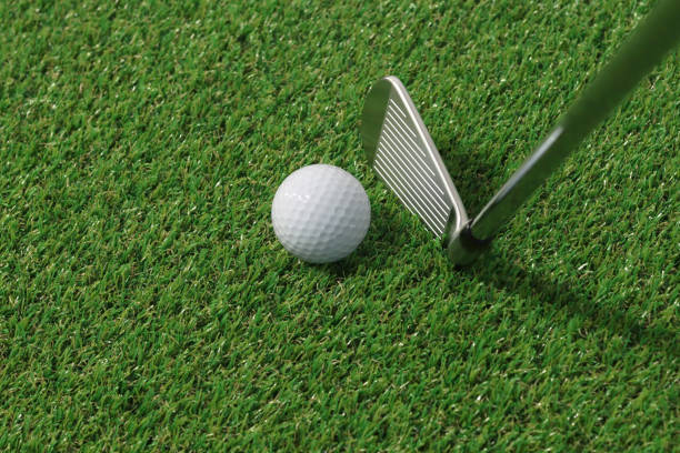 istock Golf balls and clubs on the grass 1302892745