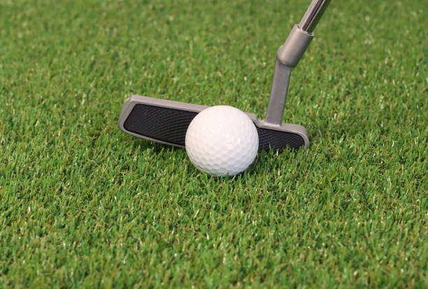 istock Golf balls and clubs on the grass 1302892750