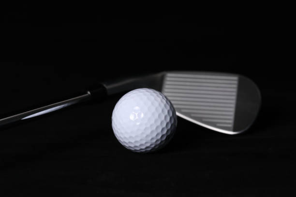 istock Black background, golf balls and clubs. 1302893662