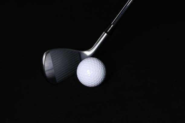 istock Black background, golf balls and clubs. 1302893664