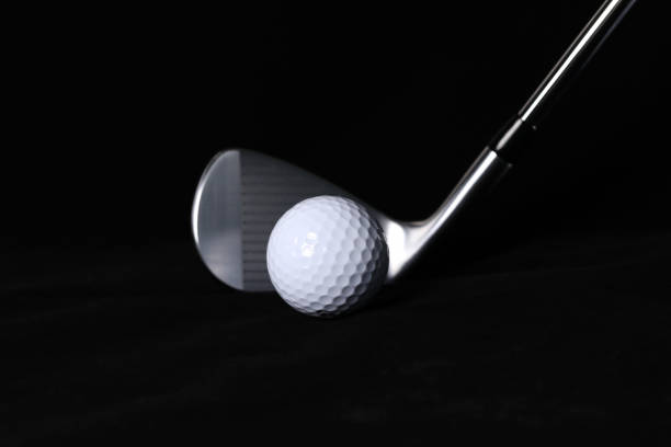 istock Black background, golf balls and clubs. 1302893671