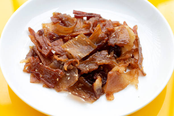 istock Sweet pork or pork Jerky on yellow background 1302893802