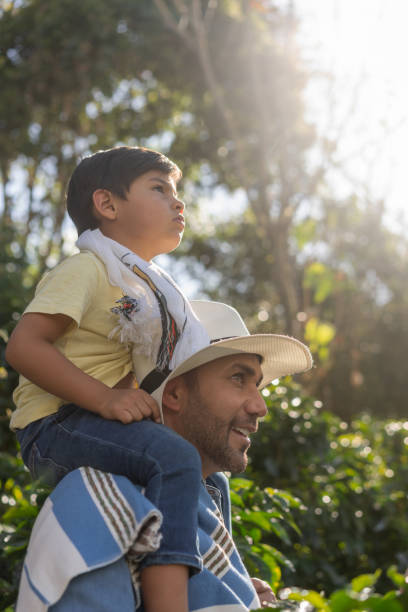 istock Happy Colombian farmer teaching his son about harvesting coffee 1302894654